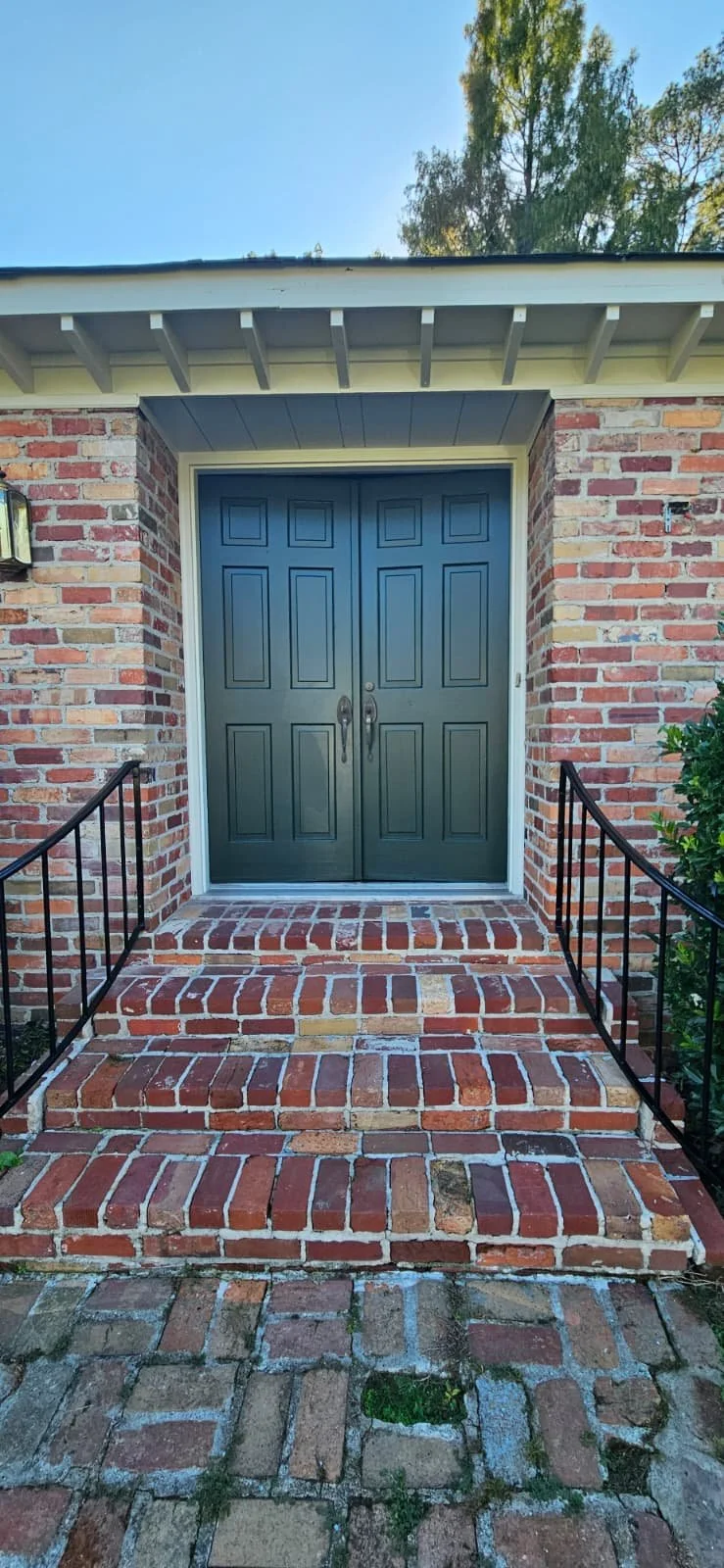 An exterior door painted black in Gadsden, Alabama.