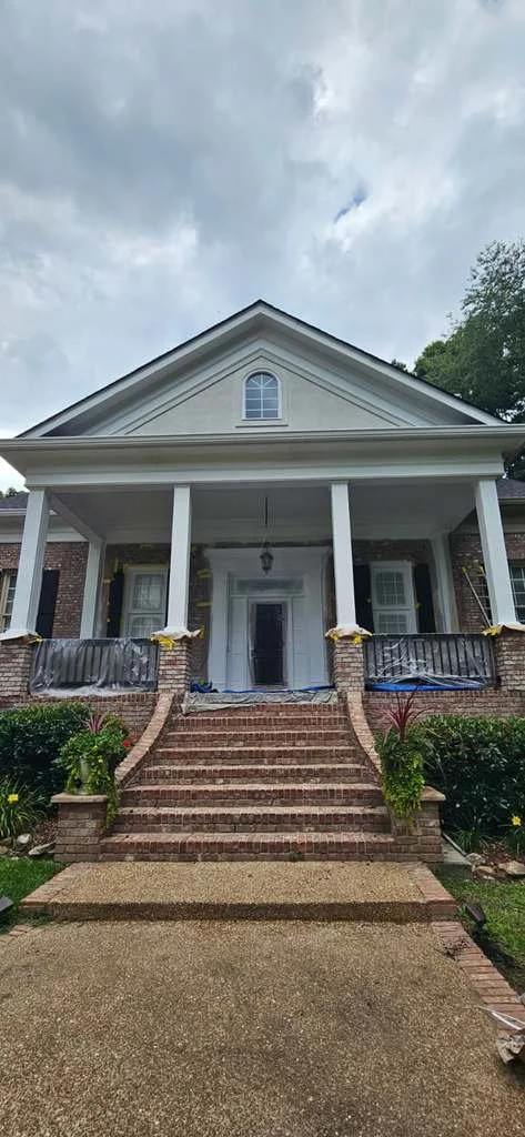 Before: An exterior painting project in Union Grove, Alabama. The brick was not touched; the stucco and the columns were painted a new color.