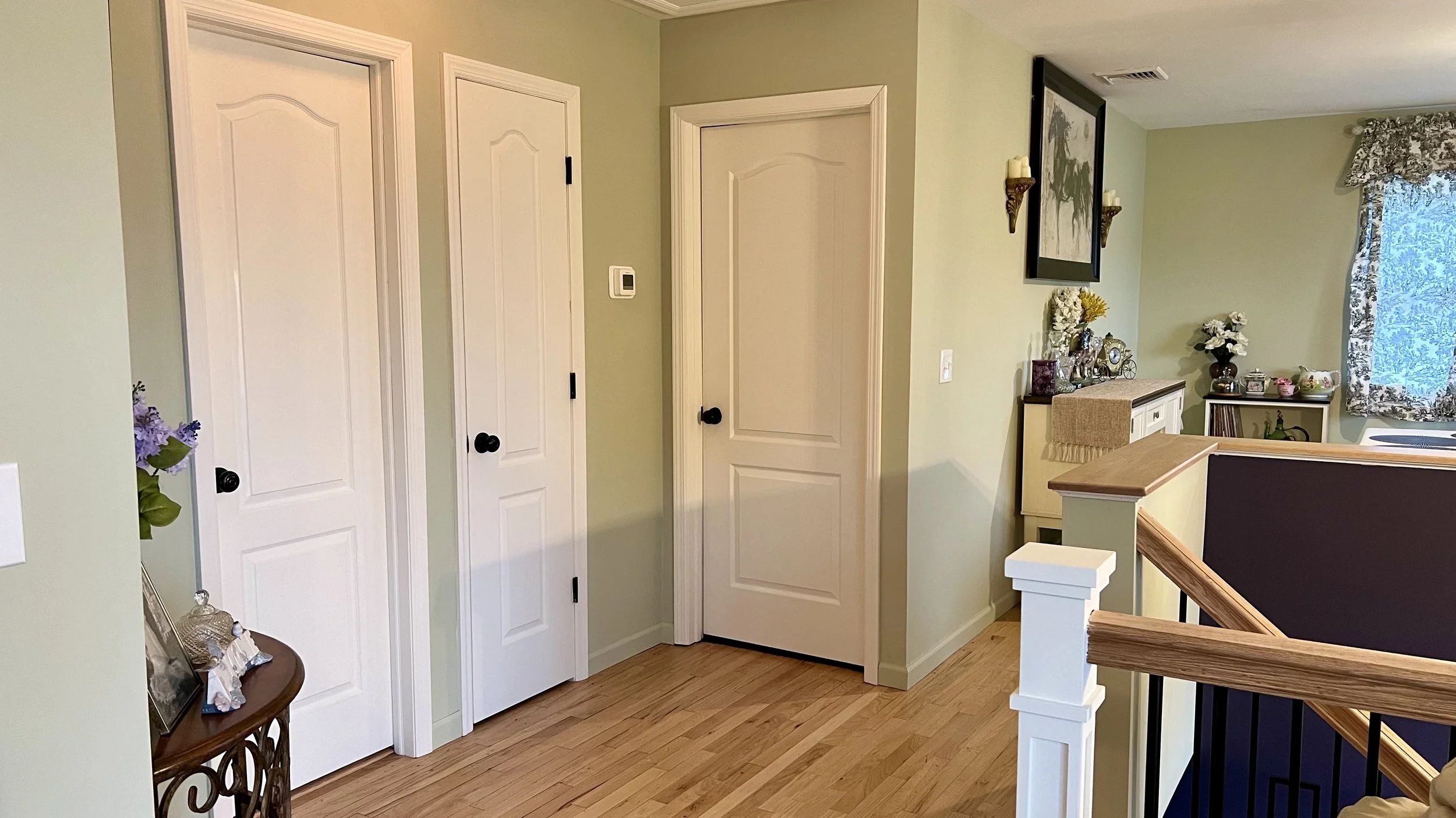 Whitney's Old House After: Hall Walls Painted a Soft Green to Create Cohesion 