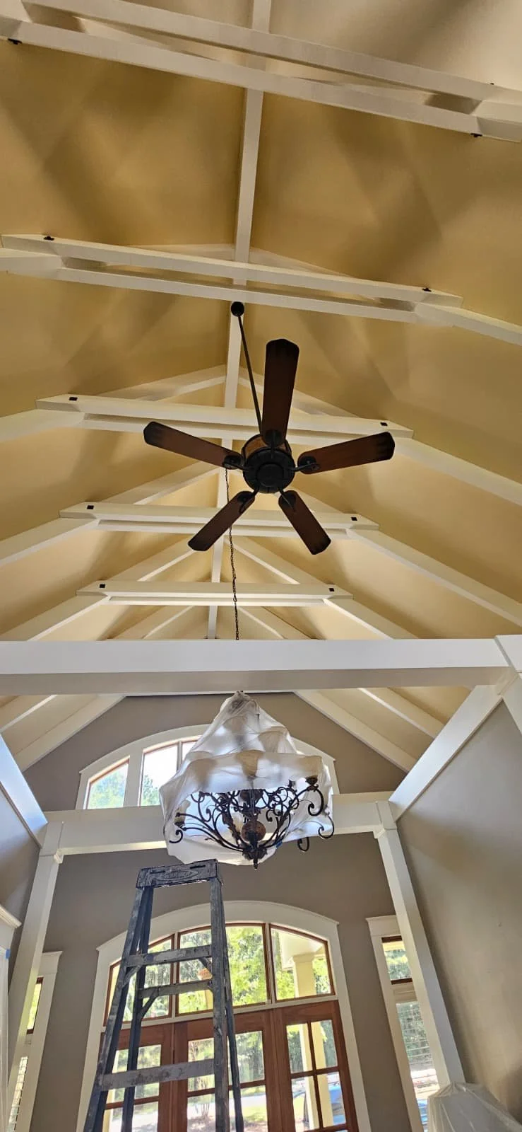 Before: An interior painting project that included painting cathedral ceilings and beams in Union Grove, Alabama.