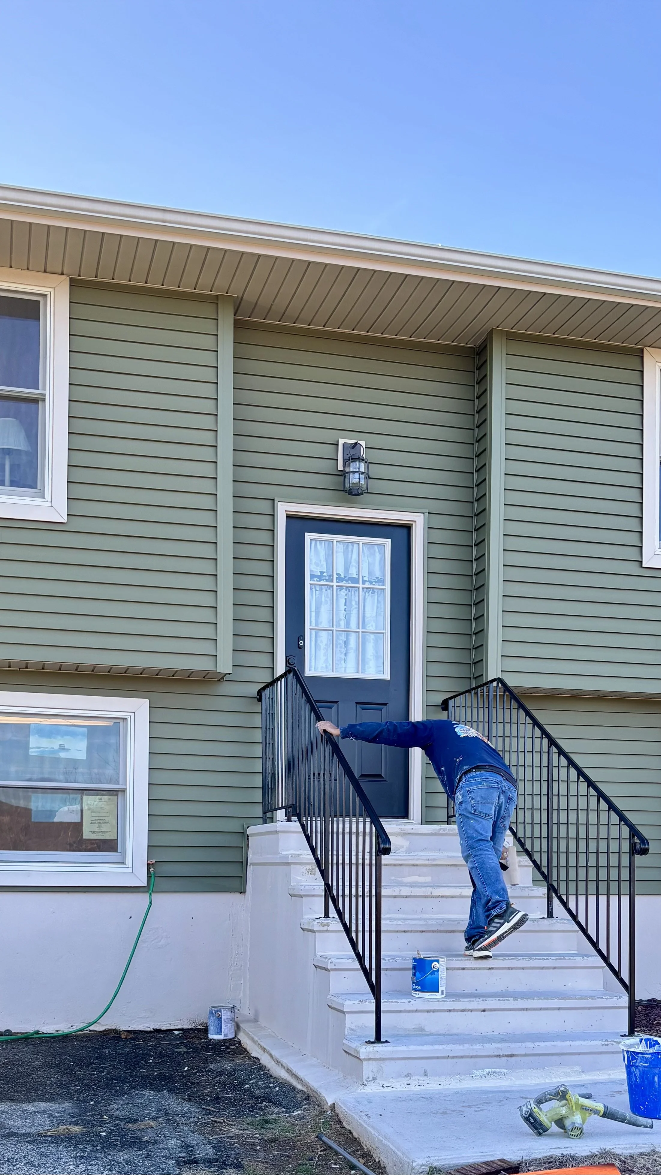 She wanted to update the front door with the same color. We color-matched the paint on the trim to ensure it was the same color, and we matched special paint to repaint her concrete stairs.