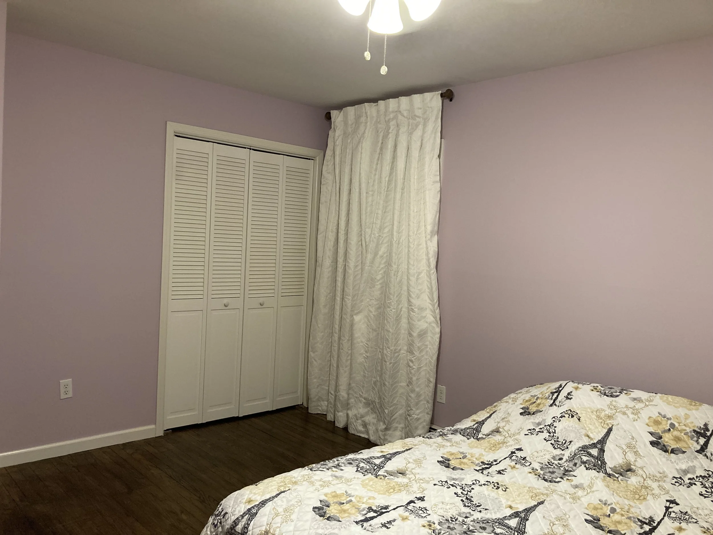 Whitney's Old House Before: Primary Bedroom was Warm Lavender & Floors were Dark Walnut