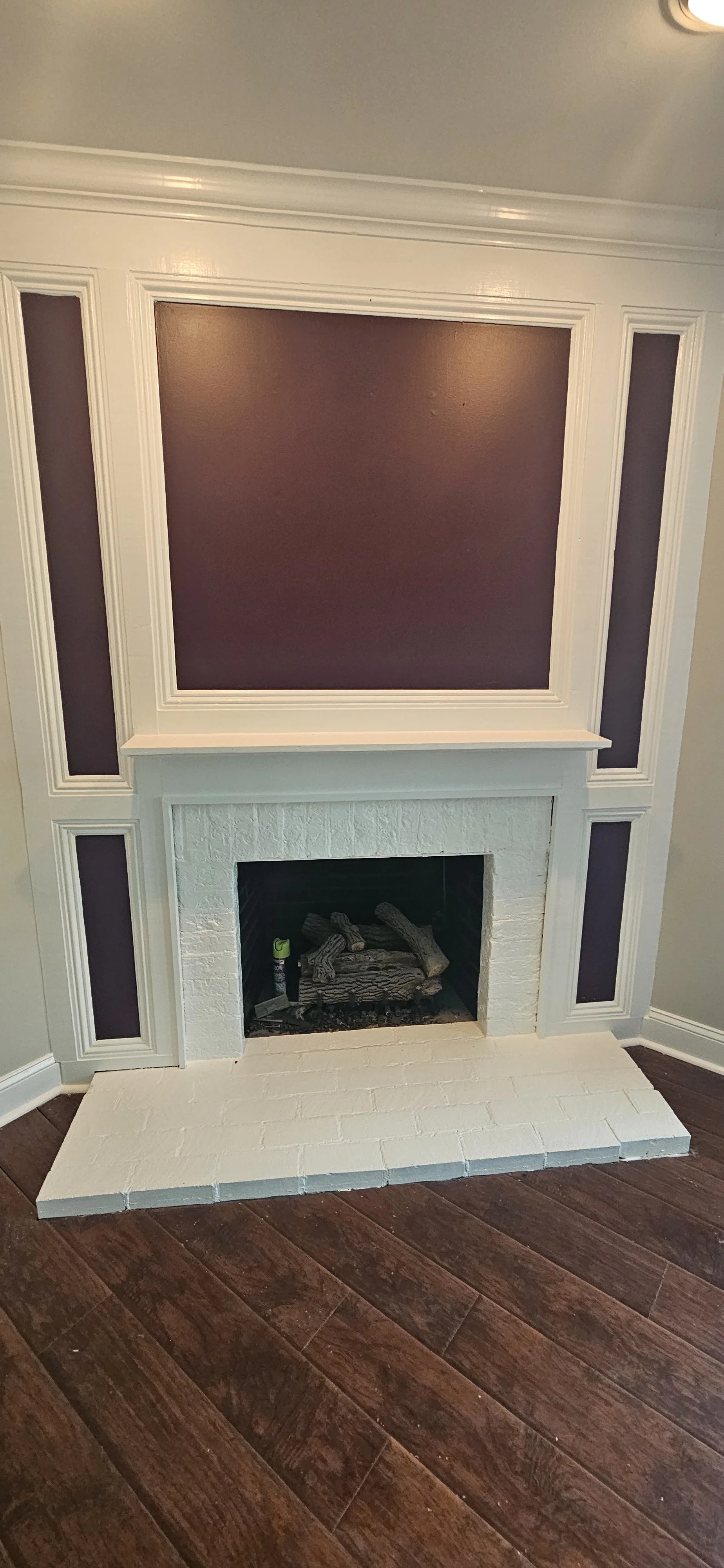 The brick fireplace, trim, and walls were painted during this project in Huntsville, Alabama.