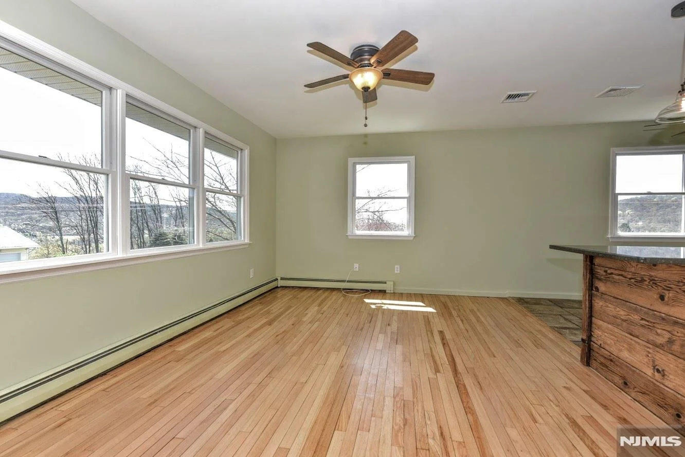Whitney's Old House After: Now a Living Room-Walls Painted Soft Green & Floors were Sanded, Coated Only with Poly