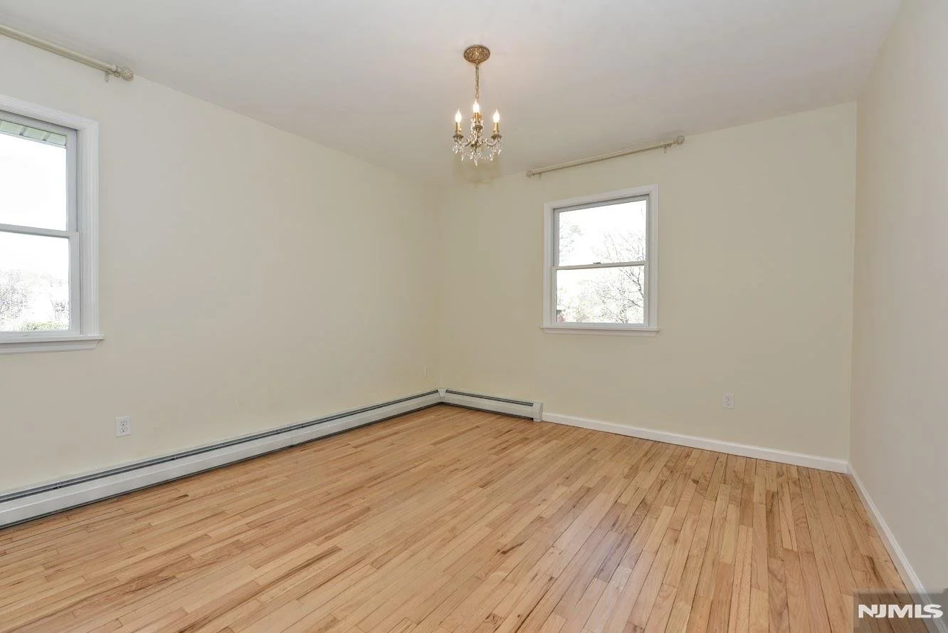 Whitney's Old House After: Primary Bedroom Painted a Creamy White & Floors were Sanded, Coated Only with Poly