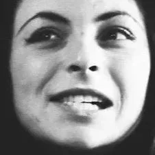 Close-up of woman's face with a slight smile and eyes looking upward.