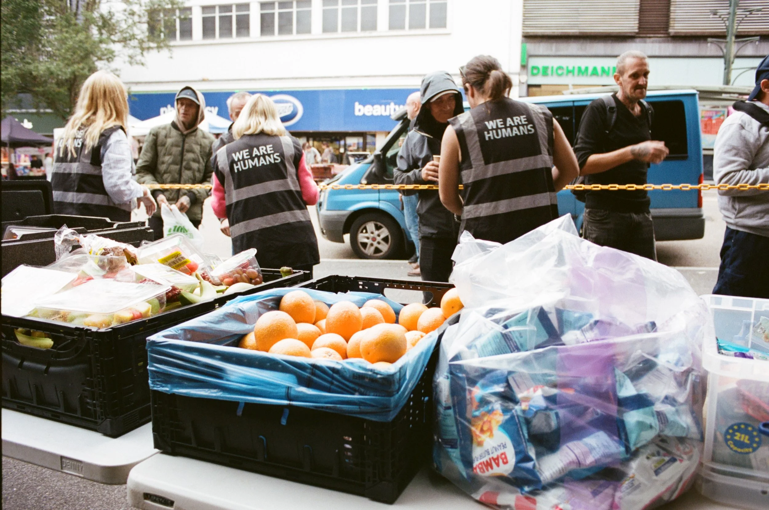 Volunteers distributing hot meals at the We Are Humans community kitchen in Bournemouth town centre – local charity poverty relief initiative.
