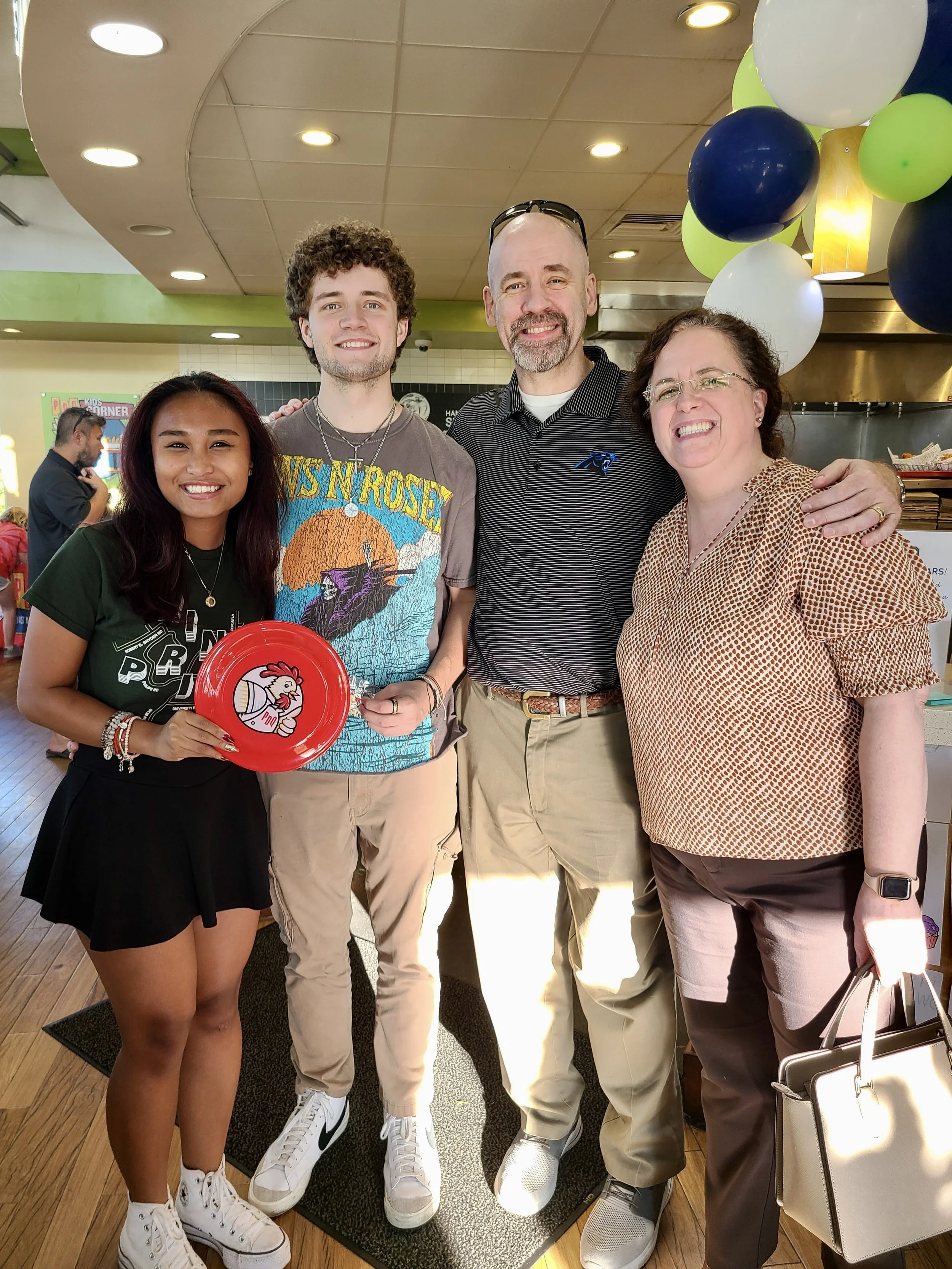 Family of four at a spirit fundraiser event smiling for the camera