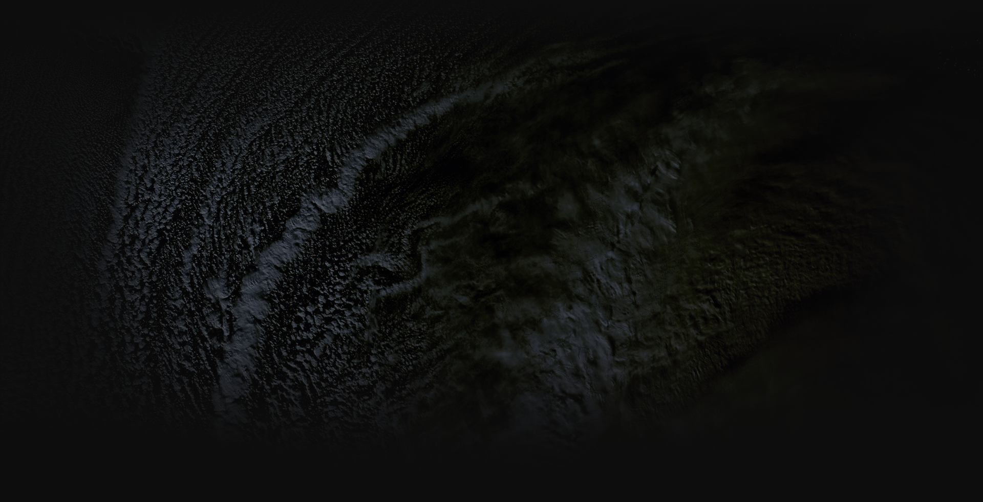 Close-up of a dark, textured surface with droplets of water or oil forming intricate patterns.