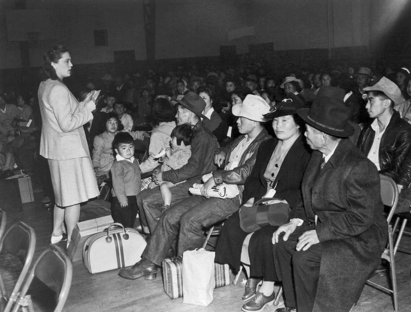 Clem Albers - Briefing of Evacuees at Buchanan-Japanese YMCA Gym.jpg