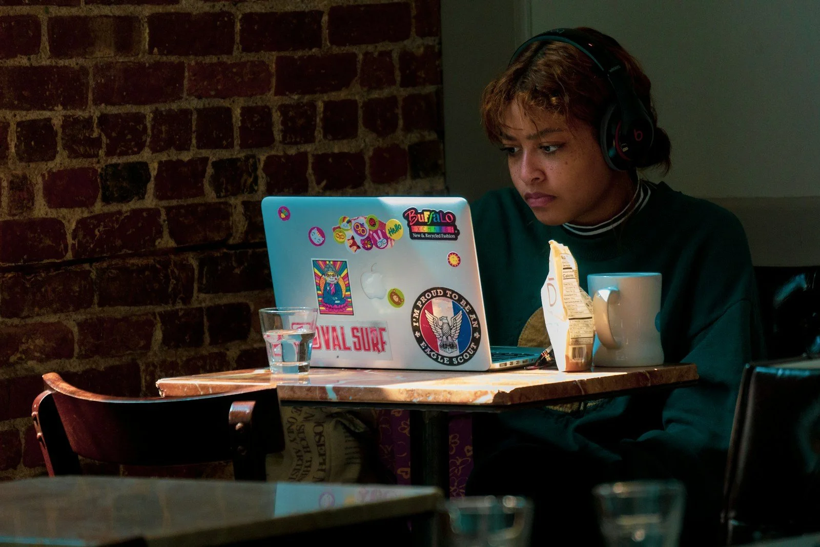 High school student working through an online course on her laptop