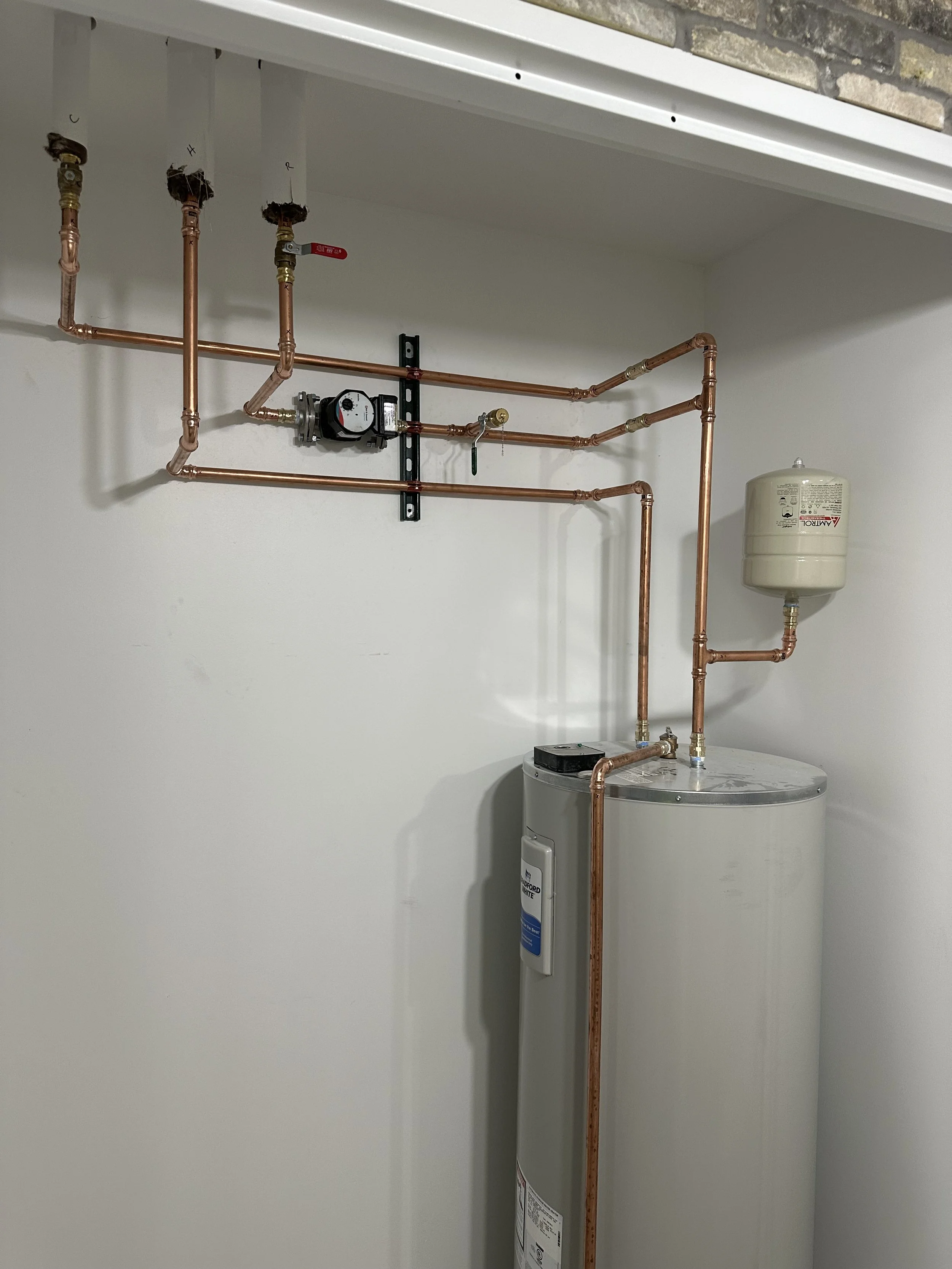 Water heater installation with copper piping and expansion tank