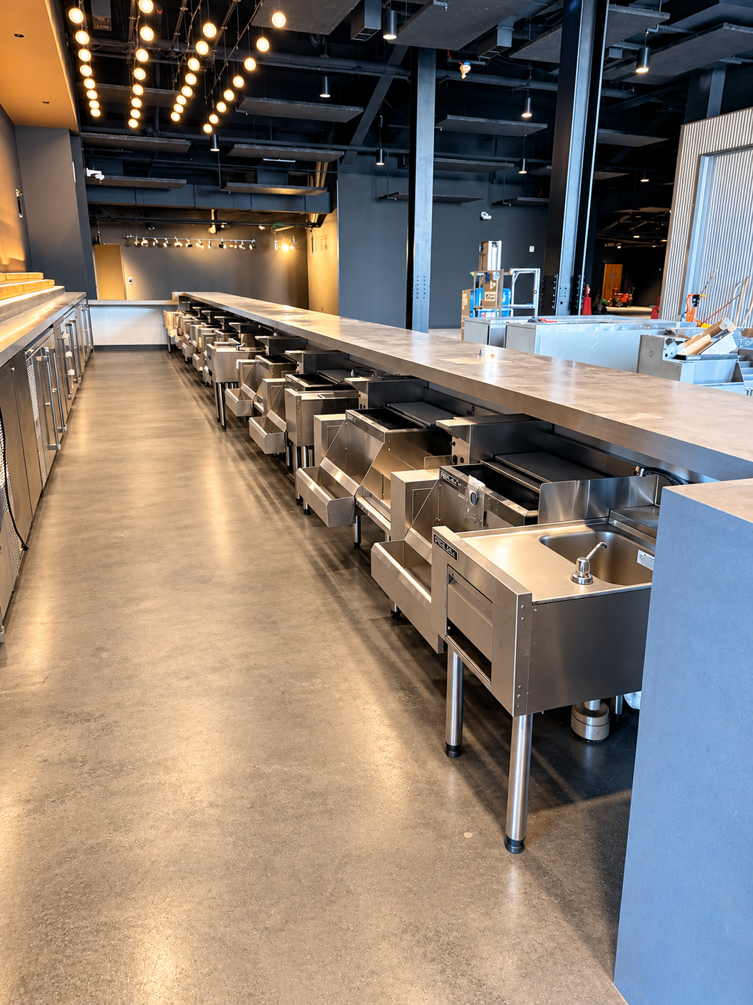 Commercial kitchen bar plumbing installation with stainless steel fixtures