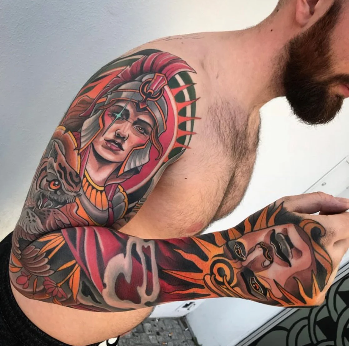 A man with tattoos on his arm and shoulder, including a detailed colorful tattoo of a woman wearing a crowned helmet and a tiger, with bold lines and bright colors. By Johnny Domus, Neo Traditional and Neo Japanese Tattoo.