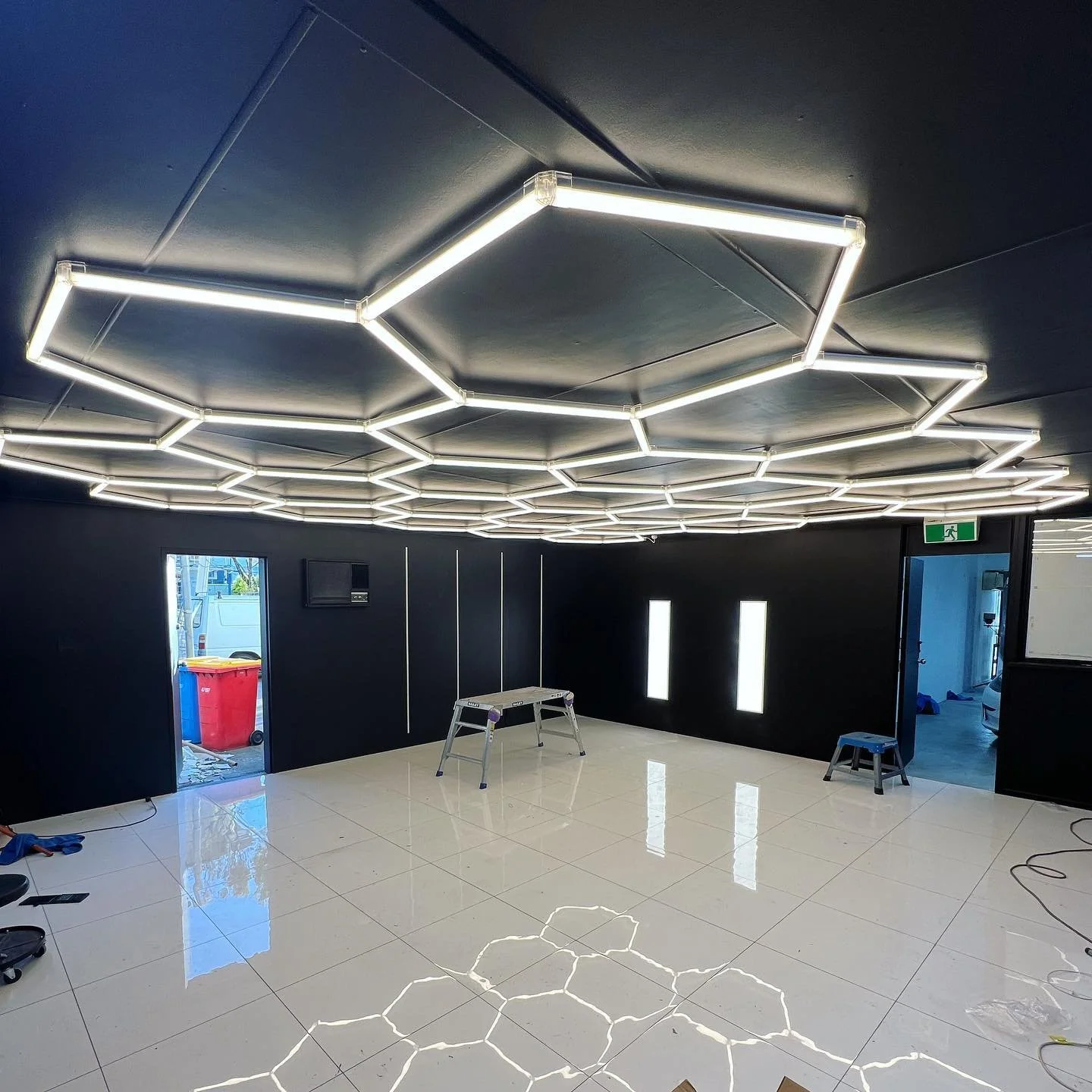 Ceiling mounted hexagonal LED lighting with recessed LED strip light &amp; LED backlit panels for @smart_pro_detailing_cairns &lsquo;s detailing bay.
This detailing bay now has great usable light to ensure your car looks like new once the boys have f