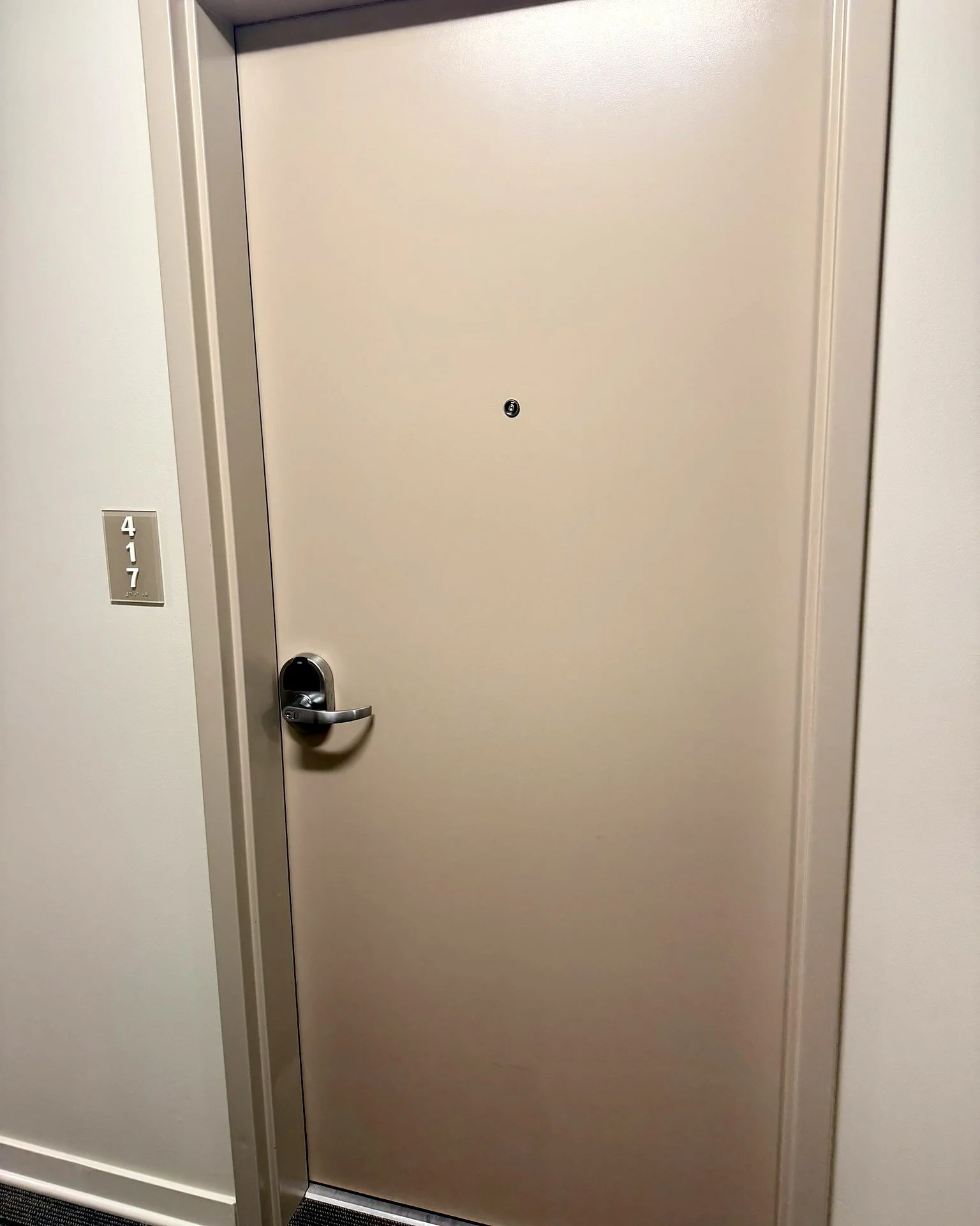 Apartment unit door fitted with a ZeroKey keyless lever lock