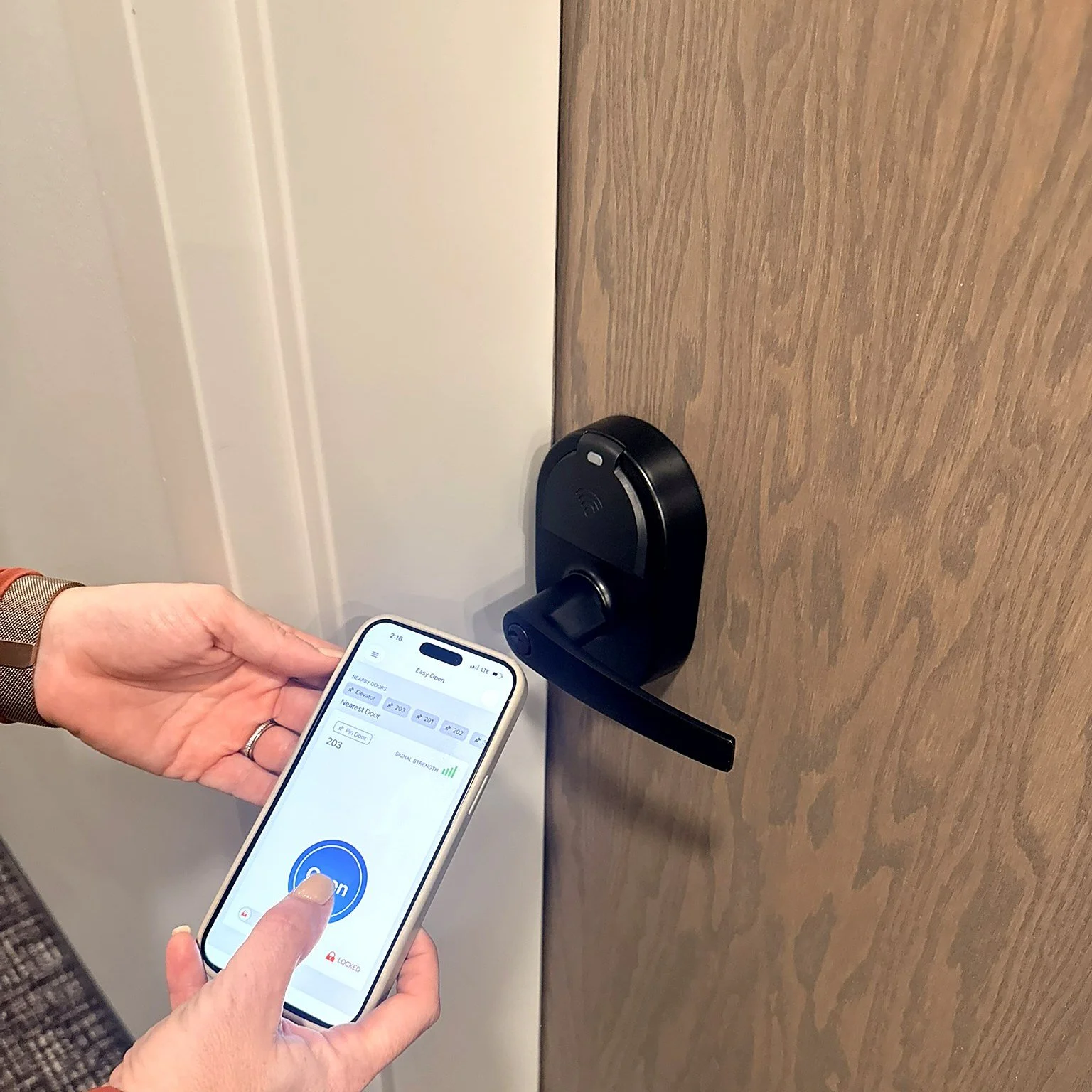 Resident unlocking an apartment door with the ZeroKey app on their phone