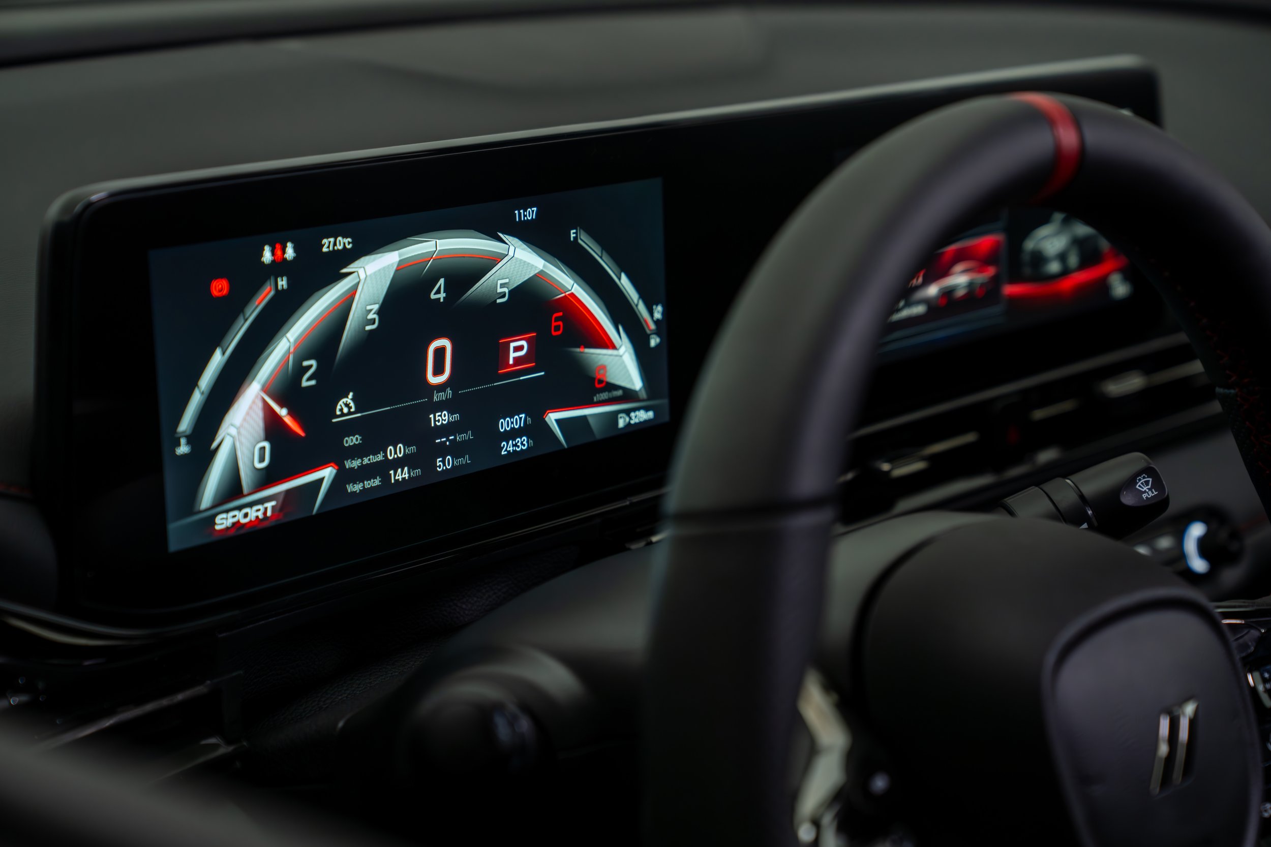 Digital dashboard of a modern car showing speed, temperature, and gear in a sporty design.