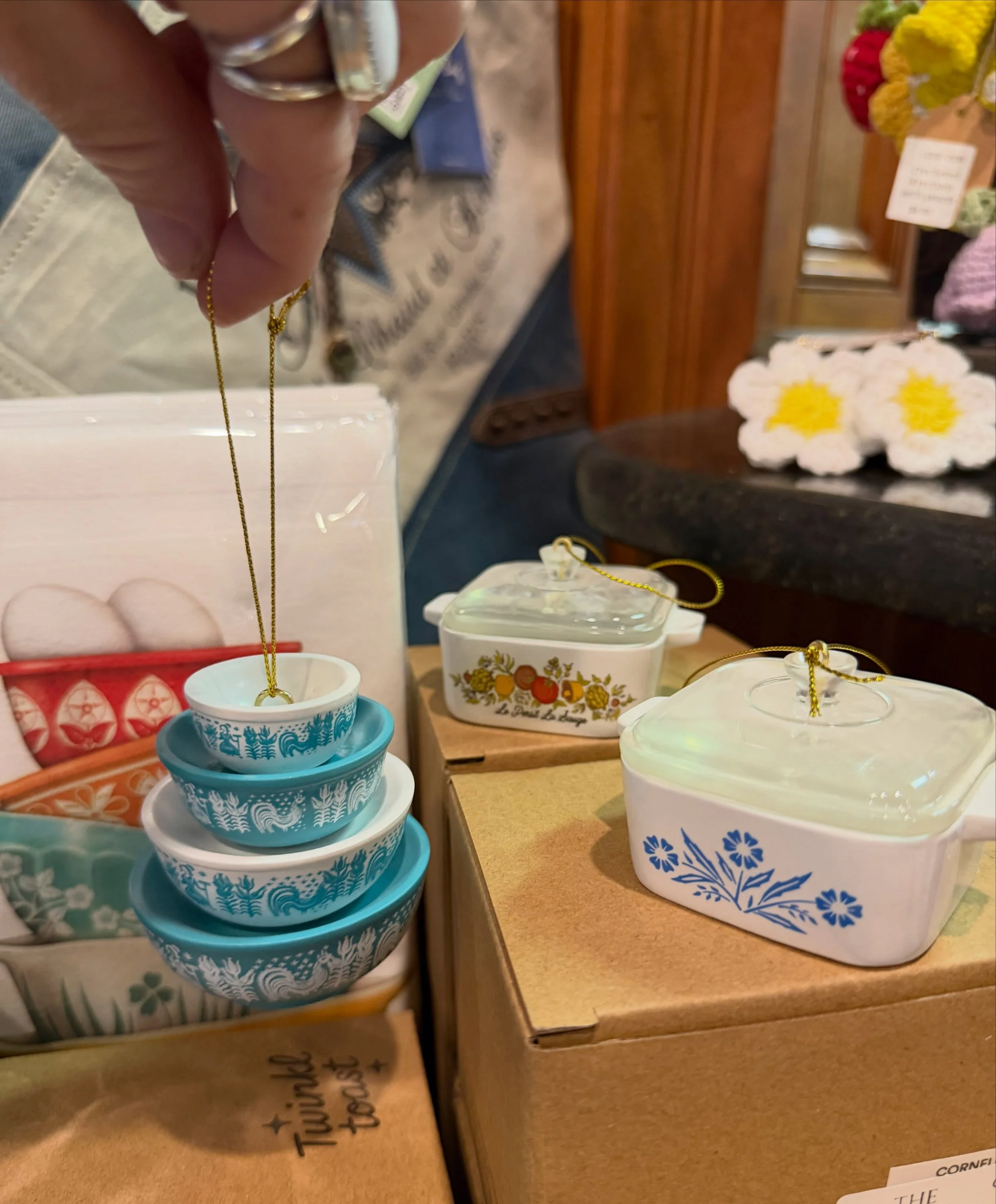 We have a lot of curated clothing options, however we have other goodies to browse and discover! Ornaments, Collectables, frames, artwork, accessories, magnets, keychains, candles, and other whimsy wares that will make you say &ldquo;oh look how ador