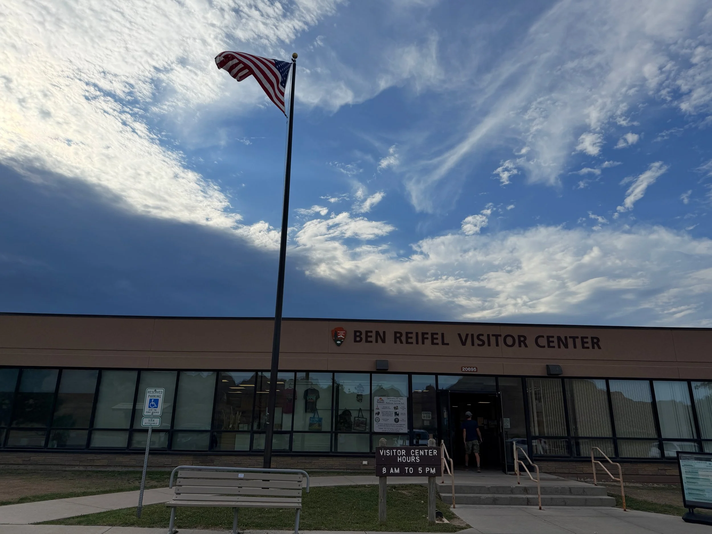 The Ben Reifel Visitor Center in Badlands National Park under a partly cloudy sky.