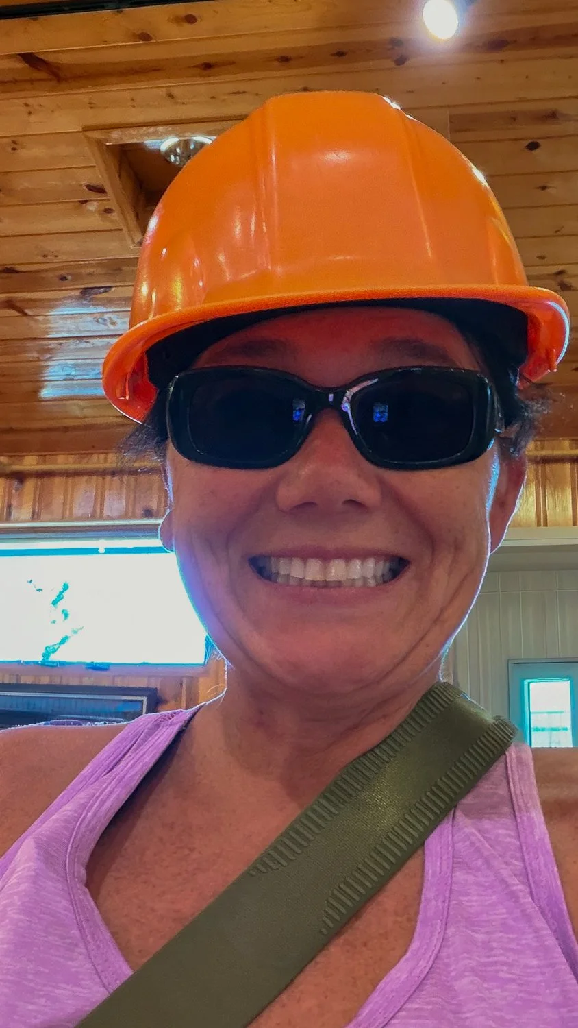 Self-portrait wearing sunglasses and a hiking hat during a visit to Crazy Horse Memorial.