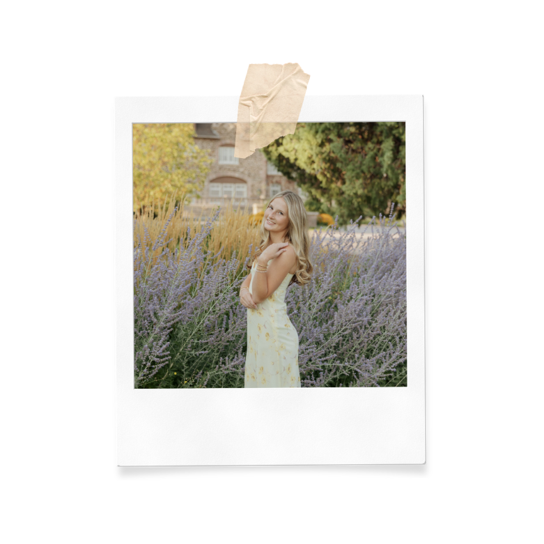 A young woman with long blonde hair wearing a light yellow dress, standing in a field of purple lavender flowers, smiling and posing for a photo.