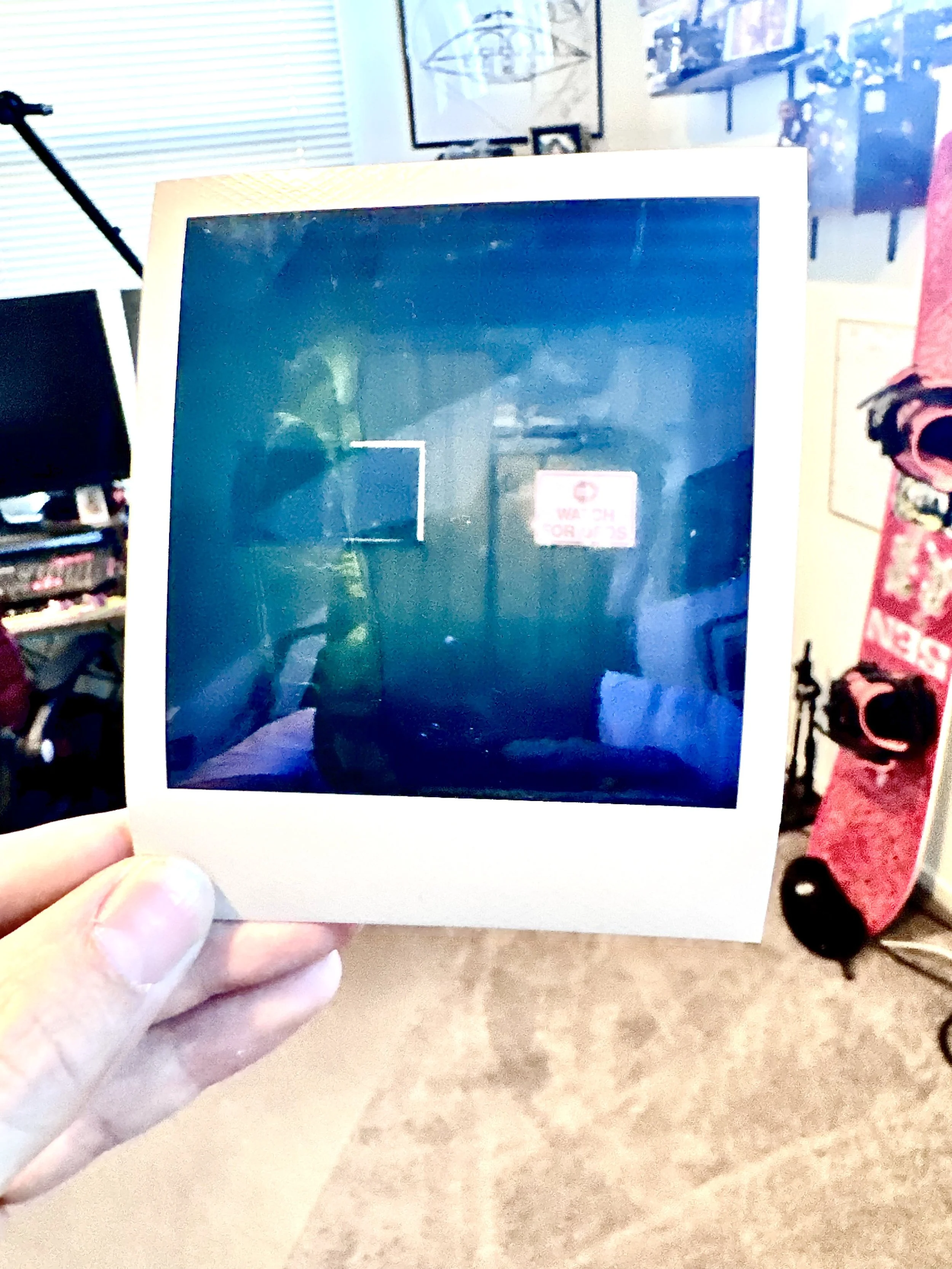 A polaroid of an anomaly caught in the corner of an investigation site looking into high strangeness. The photo shows what looks to be a manifestation of something paranormal.