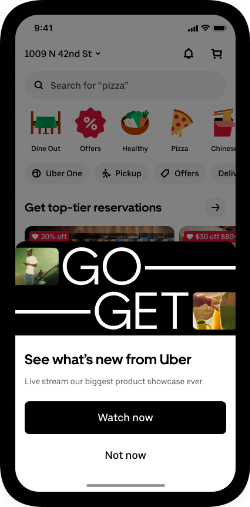 Smartphone screen showing Uber app with a pop-up about Uber's product showcase, offering options to 'Watch now' or 'Not now'.