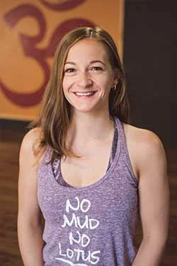 Smiling woman in purple workout top with