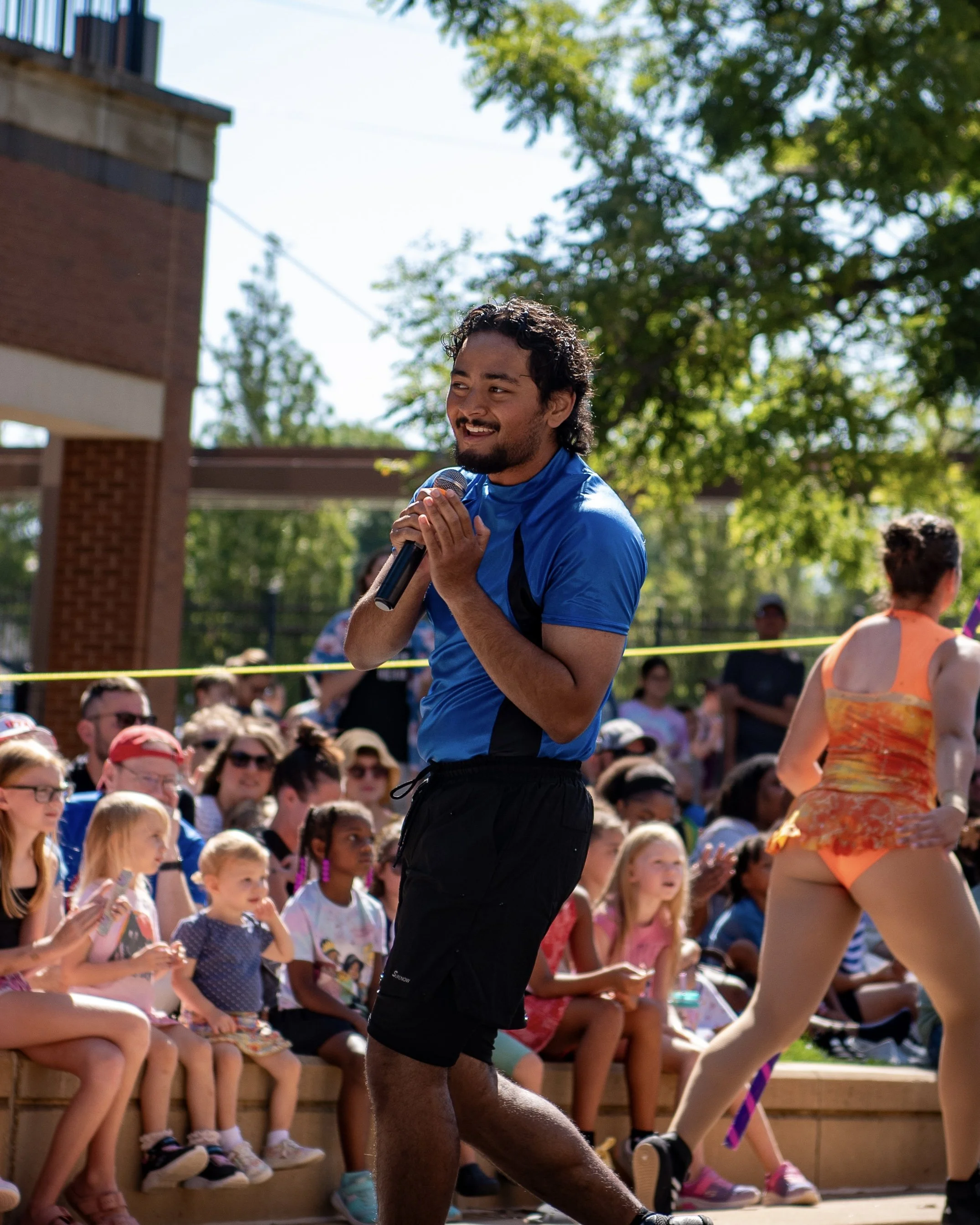 Steven Performing on a mic in front of an audience of people