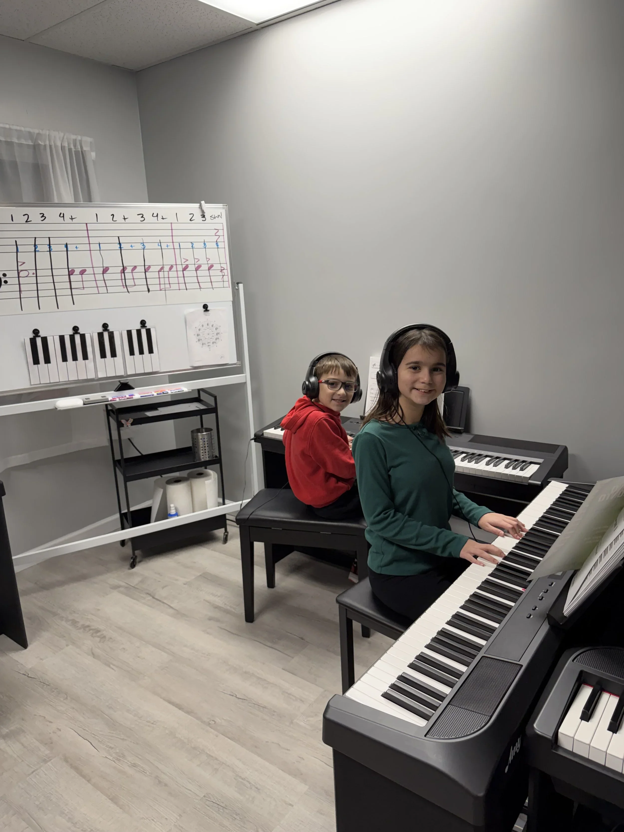 Music students sharing a lesson at Dynamic Music Studio