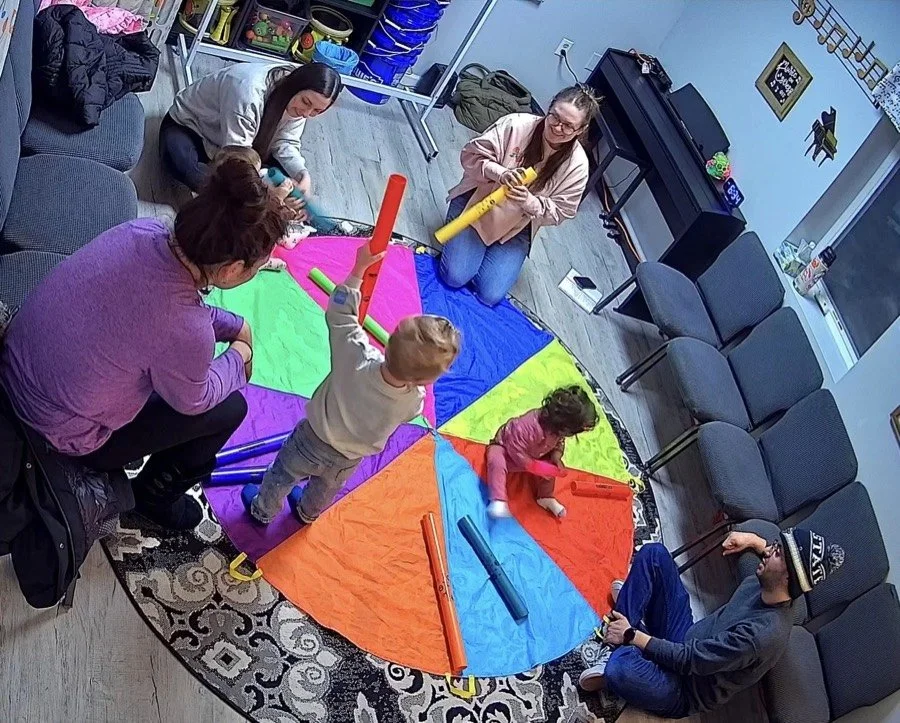 Children and adults exploring rhythm together