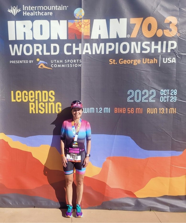 Lisa celebrating after crossing the finish line of the 70.3 World Championship, showcasing elite athletic experience for Fit with Lisa training.
