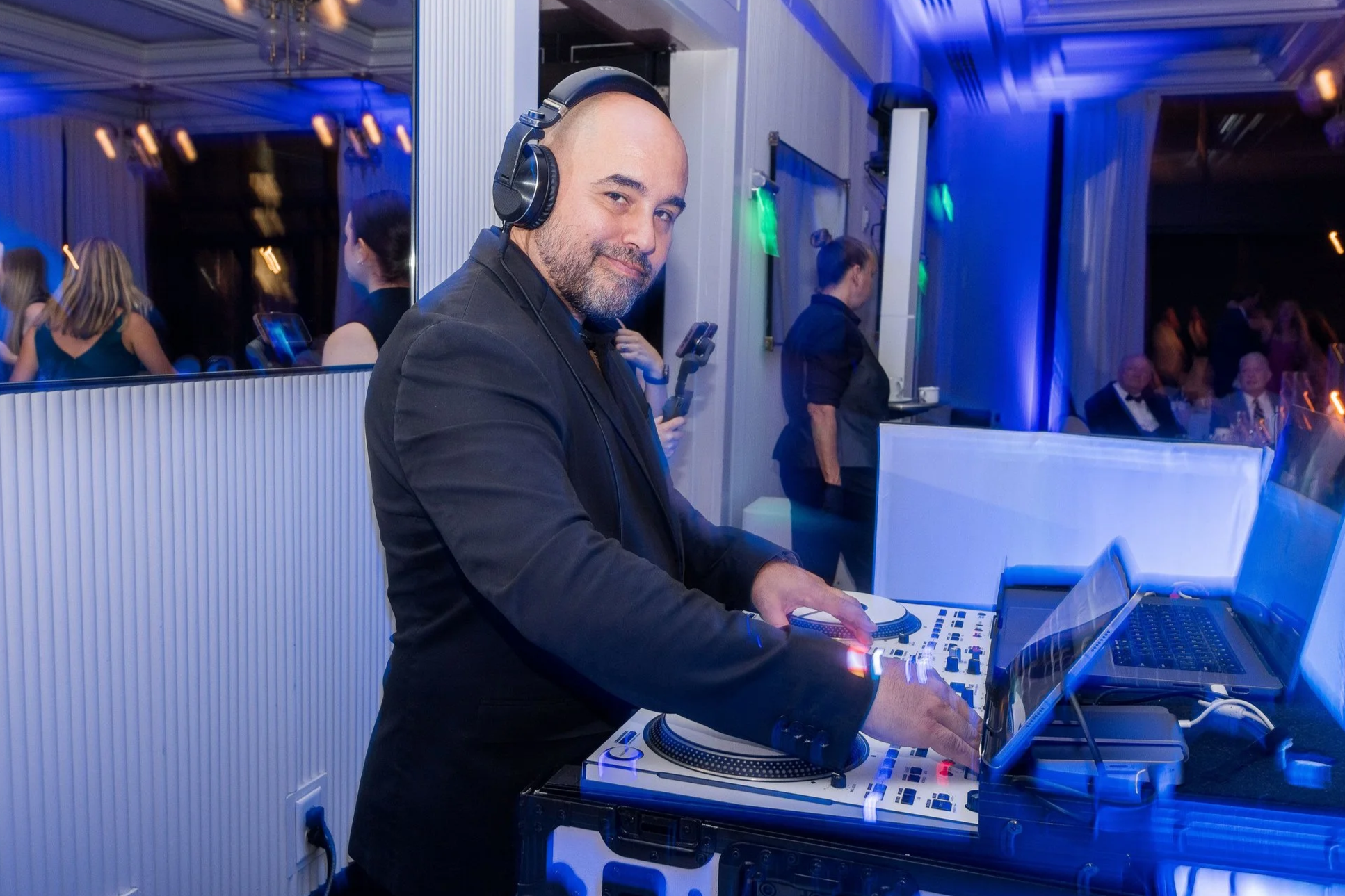 DJ César Almodóvar mixing music during a luxury wedding reception