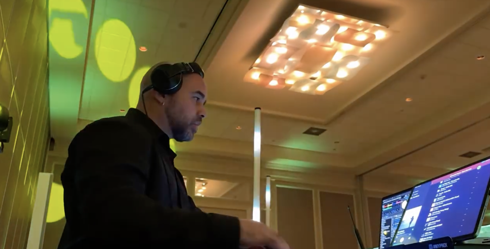DJ César operating professional lighting and music during a luxury wedding