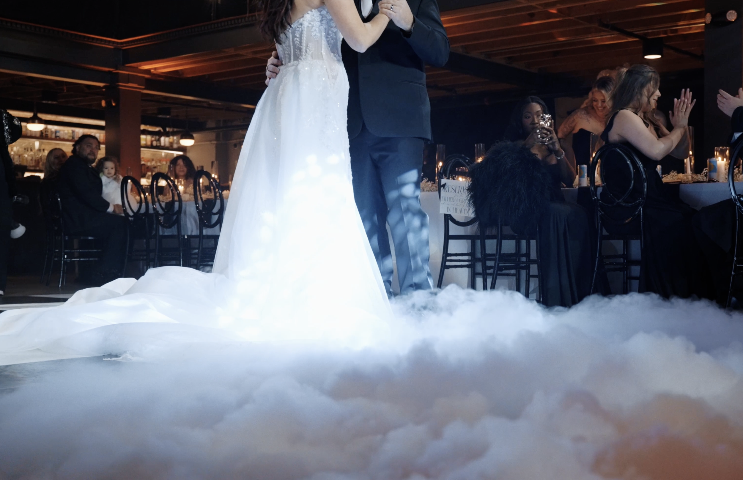 Bride and groom dancing on a low lying cloud effect during their wedding reception