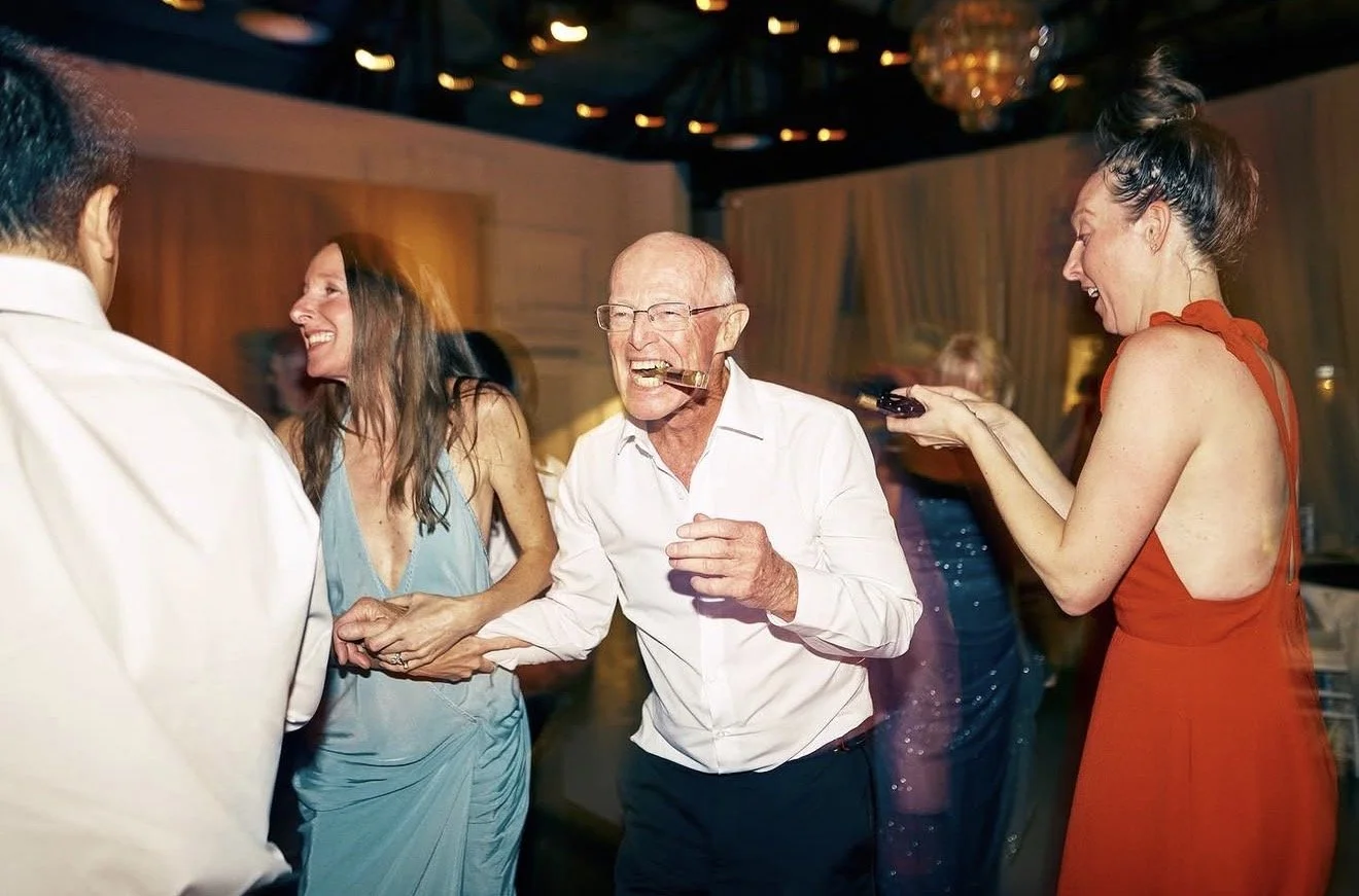 Wedding guests of all ages dancing together at the reception