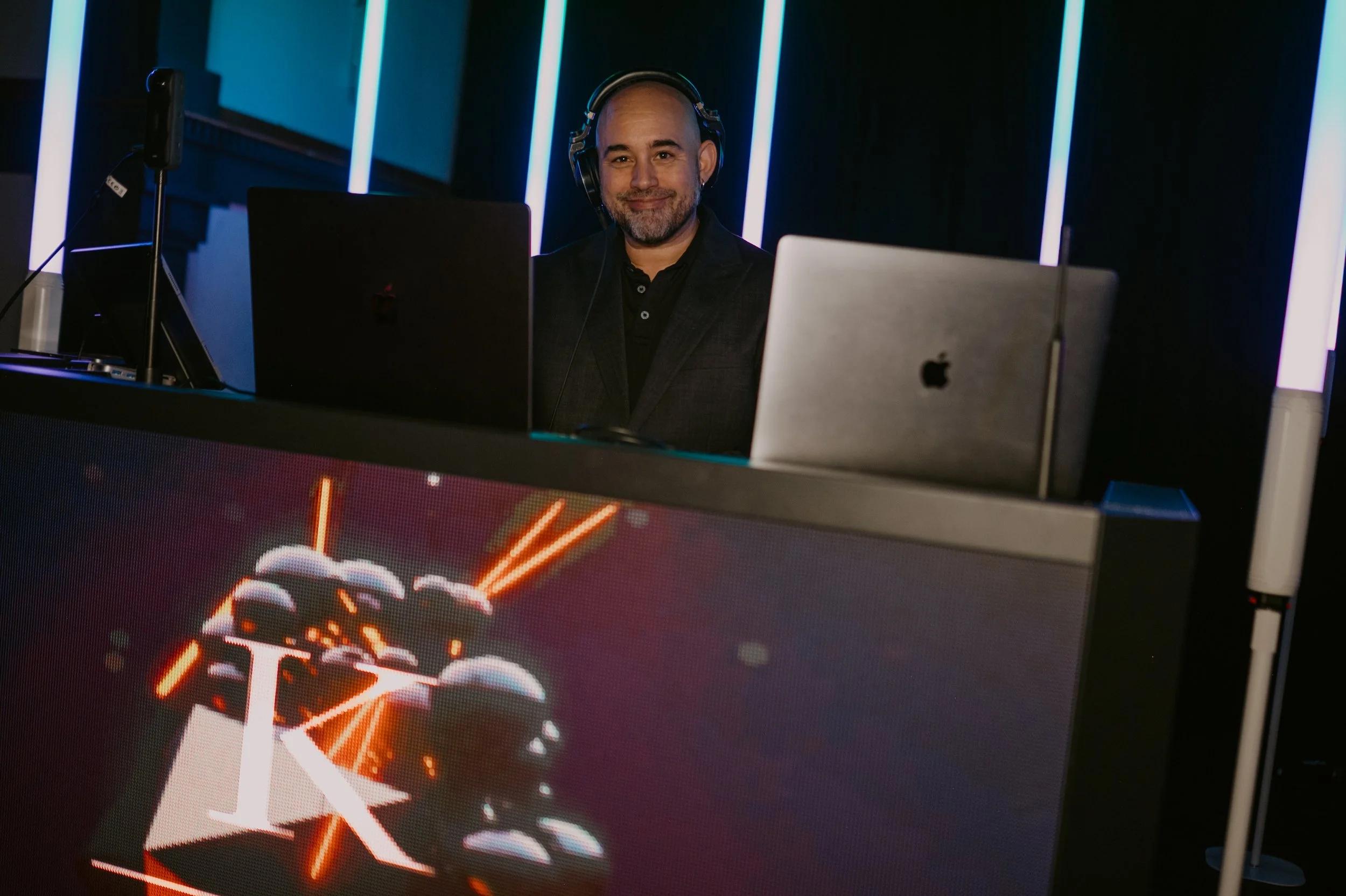 DJ César Almodóvar behind his custom LED DJ booth during a luxury wedding celebration