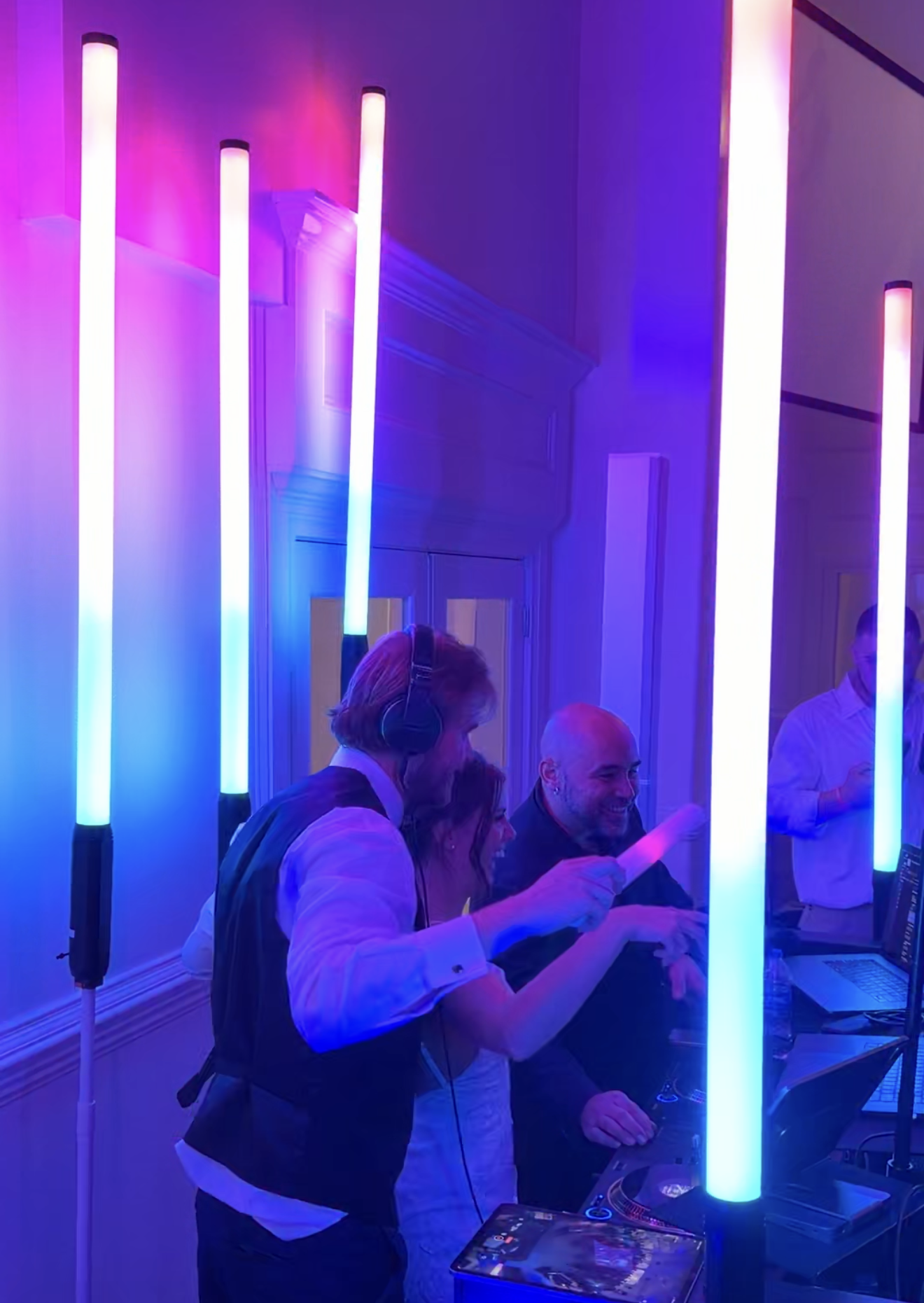 Wedding guests celebrating on a packed dance floor with DJ entertainment by Versamix Music