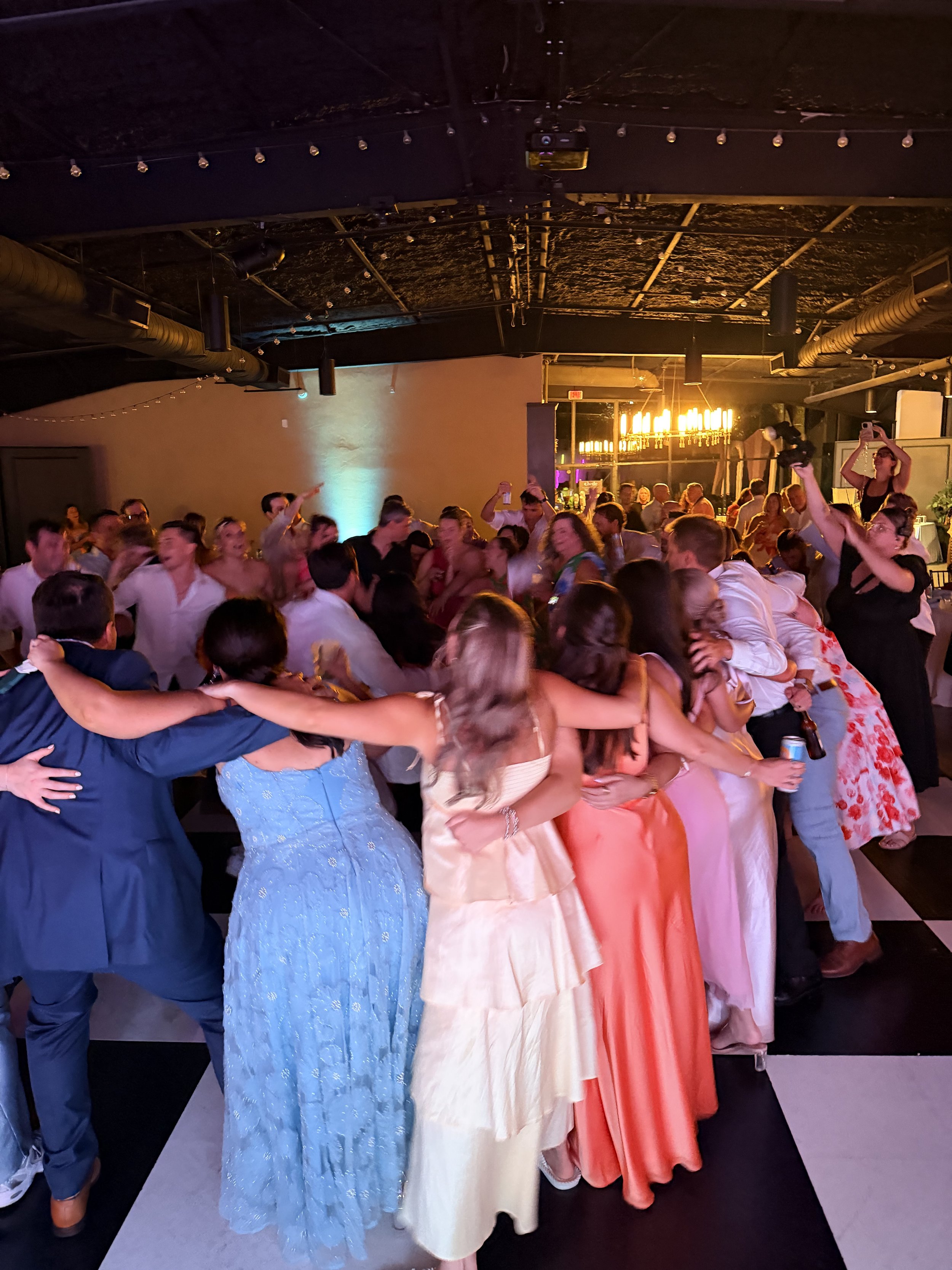 Guests celebrating together on a packed wedding dance floor in Savannah Georgia