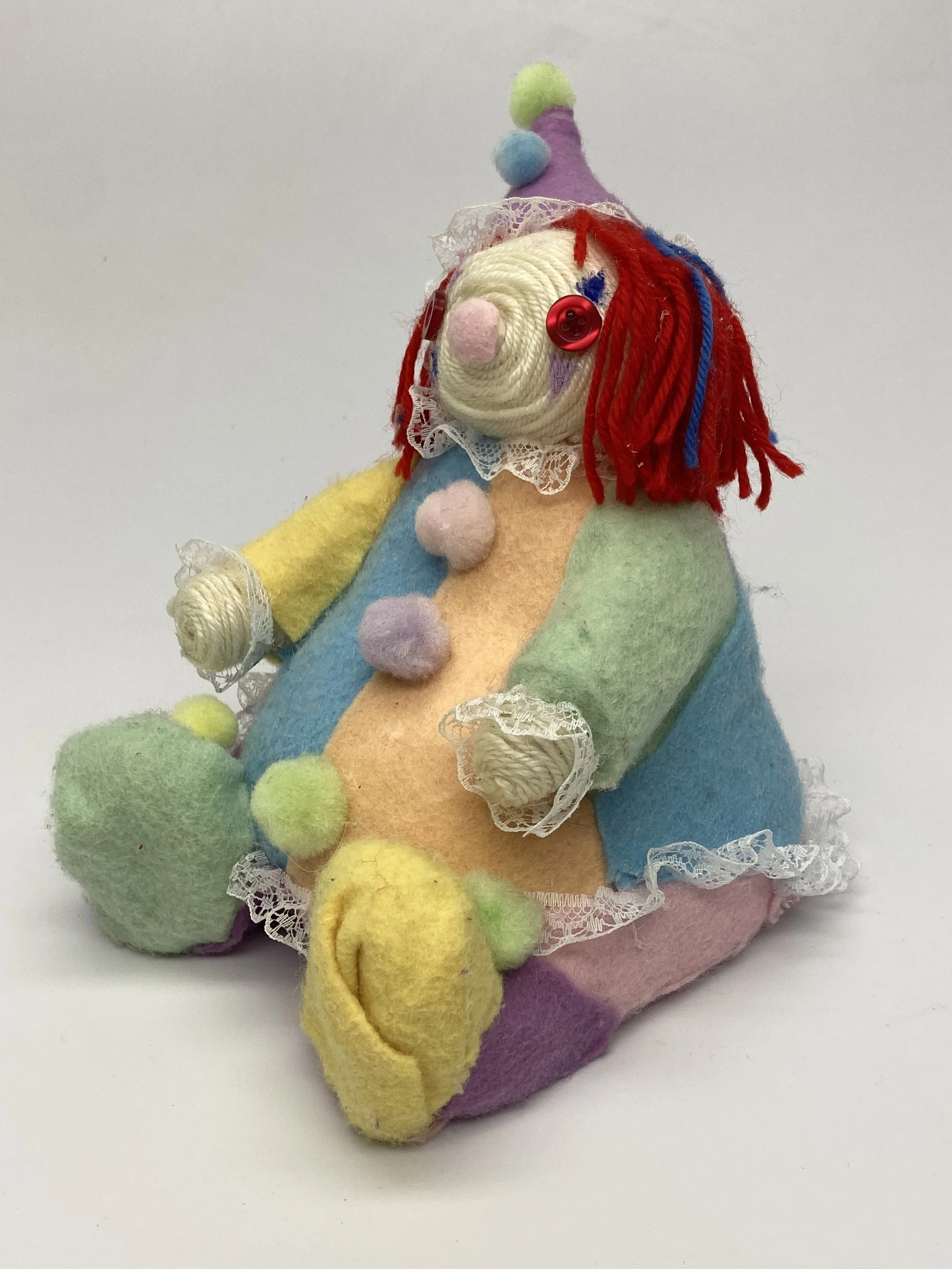 Silly Jo (front), ceramic core with yarn, felt, pompoms, and lace, 2024