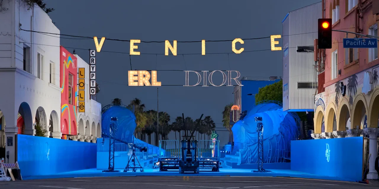 Dior and ERL runway on a closed Windward Avenue at night, under the lit Venice sign
