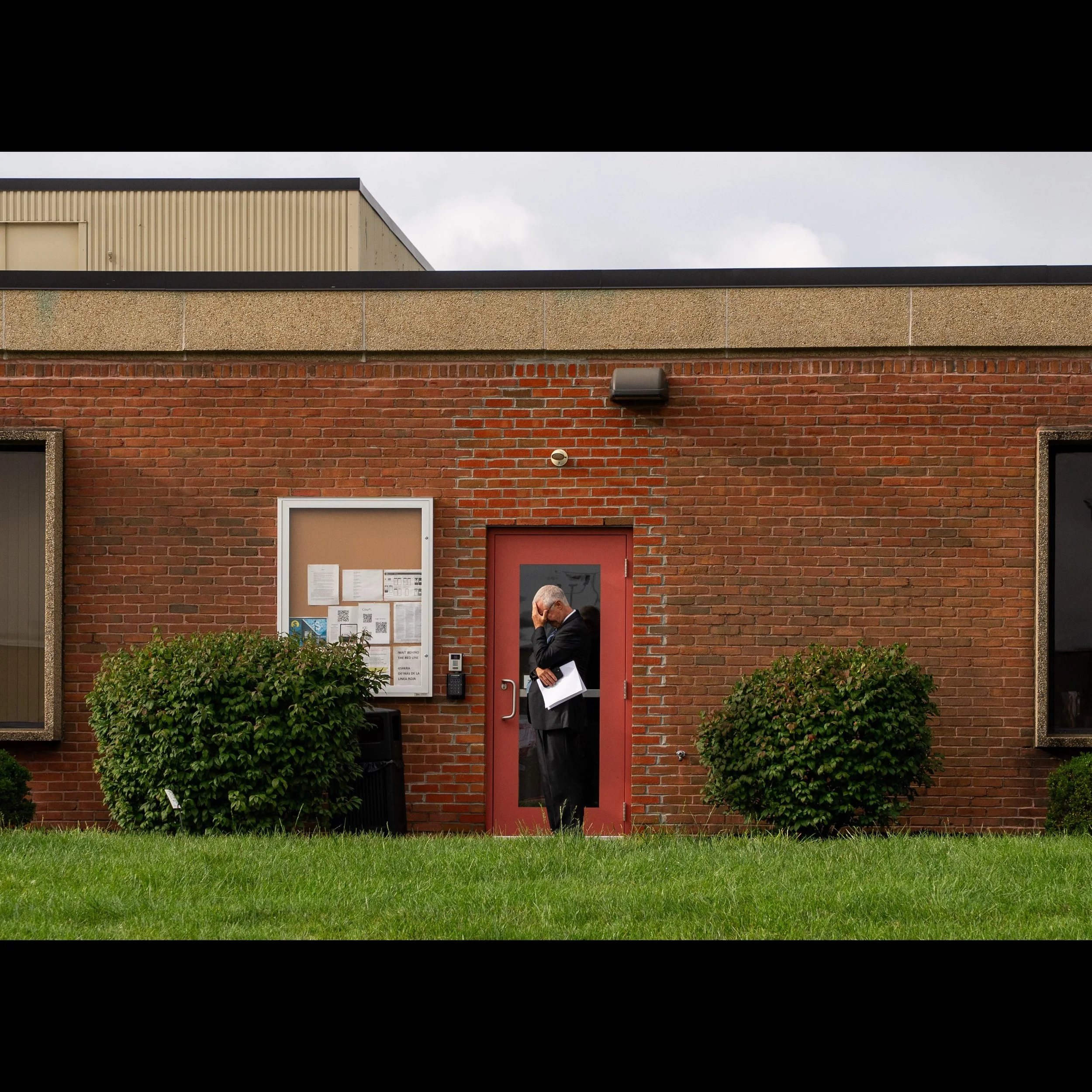 Pastor Carl Ruby of Central Christian Church in Springfield, Ohio holds his head in his hand outside of the Department of Homeland Security field office in Blue Ash, Ohio, Pastor Ruby went in support of a Haitian member of his church who was summoned