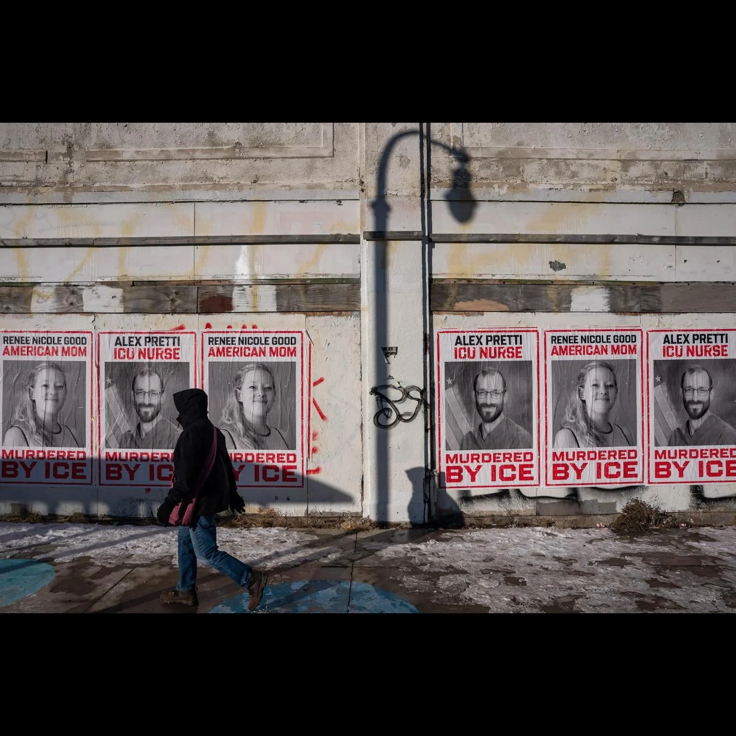 A person walks past posters commemorating Renee Nicole Good and Alex Pretti, who were both fatally shot by federal immigration agents, in Minneapolis, Minnesota, U.S., January 29, 2026. ( Photo by @seth_herald for @reuters ) #minneapolis #minnesota #