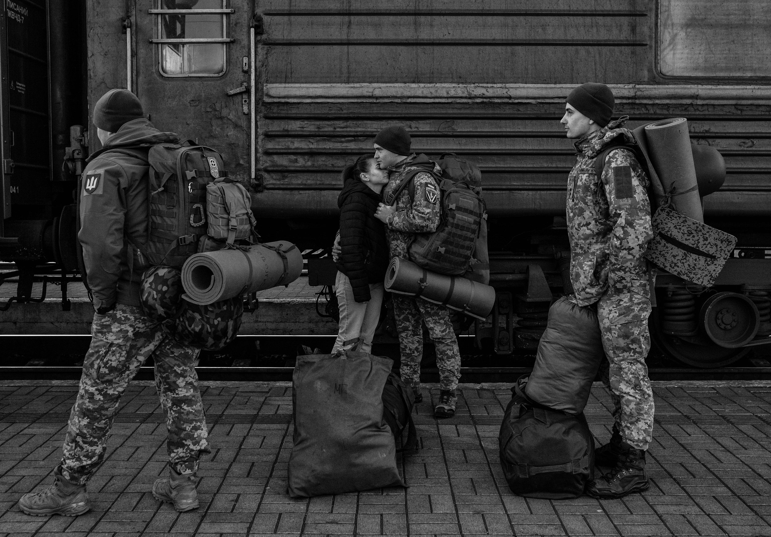  A Ukrainian soldier embraces his girlfriend while waiting to board a train heading for the frontlines at Lviv-Holovnyi railway station  as the Russian invasion of Ukraine continues on March 13,2022.  Seth Herald/Redux Pictures  