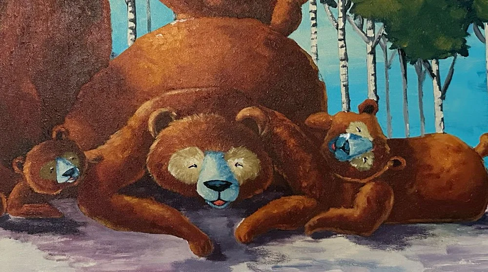 Un oso grande y dos osos pequeños descansando en un bosque