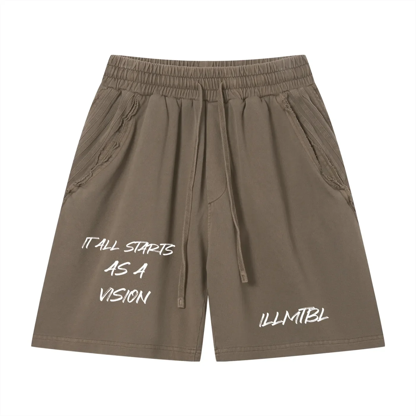 A pair of tan shorts with an elastic waistband and drawstring, accented with pleated details on the pockets. White text on the shorts reads, 'IT ALL STARTS AS A VISION' and 'ILLMTBL'.