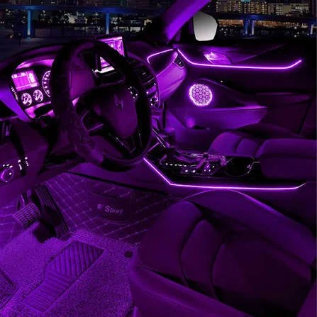 Interior of a car illuminated with purple LED lights, featuring a steering wheel, dashboard, and center console.