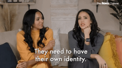 Two women sitting on a couch talking, with text overlay: "They need to have their own identity."