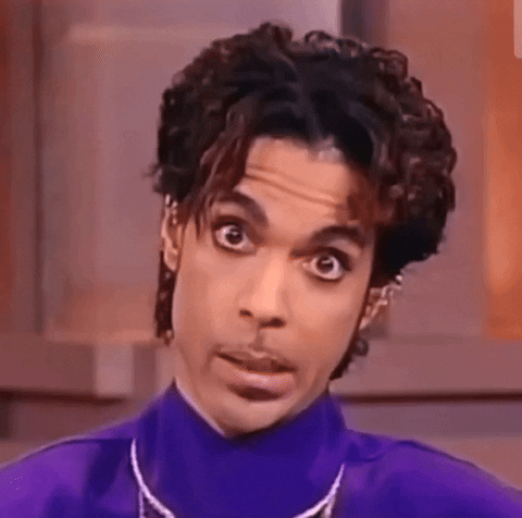 A person with a surprised or confused expression, wearing a blue shirt.